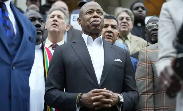 New York City Mayor Eric Adams is surrounded by faith leaders and other supporters during a rally and prayer vigil on the steps of City Hall in New York, Tuesday, Oct. 1, 2024. (AP Photo/Seth Wenig)