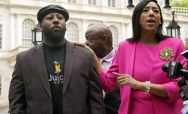 Shamel Kelly, left, is introduced by his attorney Bernarda Villalona, during a news conference in New York's City Hall Park, Tuesday, Oct. 1, 2024. (AP Photo/Richard Drew)