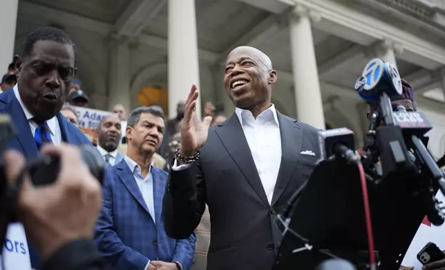 New York City Mayor Eric Adams speaks while surrounded by faith leaders and other supporters during a rally and prayer vigil on the steps of City Hall in New York, Tuesday, Oct. 1, 2024. (AP Photo/Seth Wenig)