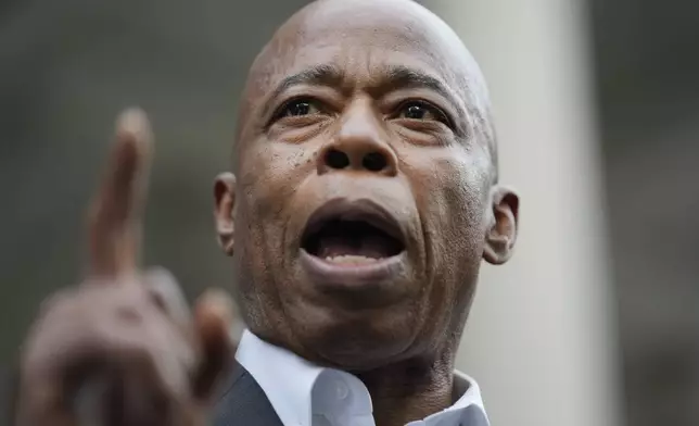 New York City Mayor Eric Adams speaks while surrounded by faith leaders and other supporters during a rally and prayer vigil on the steps of City Hall in New York, Tuesday, Oct. 1, 2024. (AP Photo/Seth Wenig)