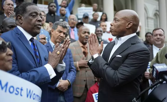 New York City Mayor Eric Adams, right, thanks faith leaders and other supporters during a rally and prayer vigil on the steps of City Hall in New York, Tuesday, Oct. 1, 2024. (AP Photo/Seth Wenig)