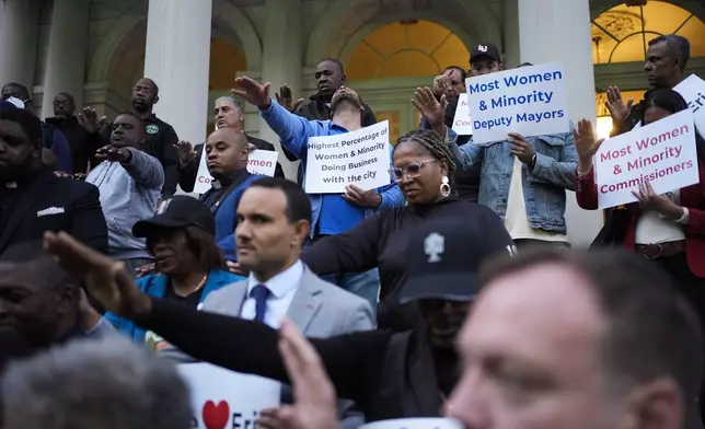 Faith leaders and other supporters pray over New York City Mayor Eric Adams during a rally and prayer vigil on the steps of City Hall in New York, Tuesday, Oct. 1, 2024. (AP Photo/Seth Wenig)