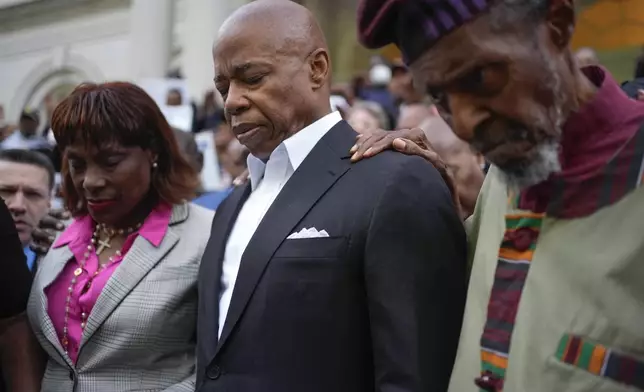 Faith leaders and other supporters pray over New York City Mayor Eric Adams, center, during a rally and prayer vigil on the steps of City Hall in New York, Tuesday, Oct. 1, 2024. (AP Photo/Seth Wenig)