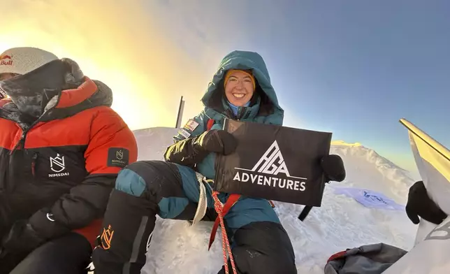 Adriana Brownlee, 23, youngest woman to scale all the world's 14 highest peaks, pose for a photograph at the summit of Shishapangma Tibet, Wednesday, Oct. 9, 2024. (AGA Adventures via AP)