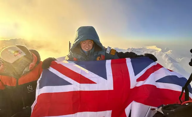 Adriana Brownlee, 23, youngest woman to scale all the world's 14 highest peaks, poses for a photograph at the summit of Shishapangma Tibet, Wednesday, Oct. 9, 2024. (AGA Adventures via AP)