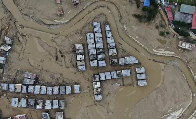 In this aerial image of the Kathmandu valley, a locality is swamped in mud in Kathmandu, Nepal, Monday, Sept. 30, 2024 in the aftermath of a flood caused by heavy rains. (AP Photo/Gopen Rai)