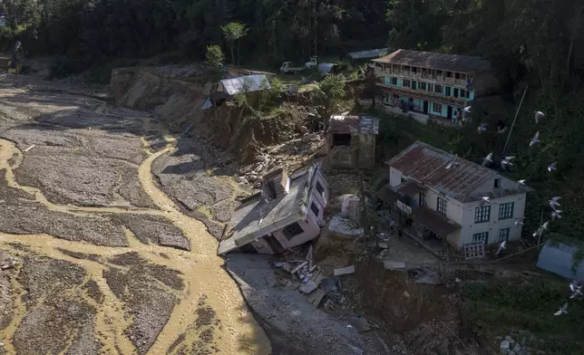 In this aerial view of Lalitpur, buildings damaged in the floods caused by heavy rains are seen, in Nepal, on Tuesday, Oct. 1, 2024. (AP Photo/Niranjan Shrestha)