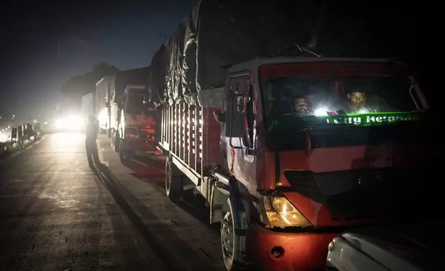 Truck drivers wait inside their vehicles as they wait for road to get cleared following landslides near Kathmandu, Nepal, on Tuesday, Oct. 1, 2024. (AP Photo/Niranjan Shrestha)