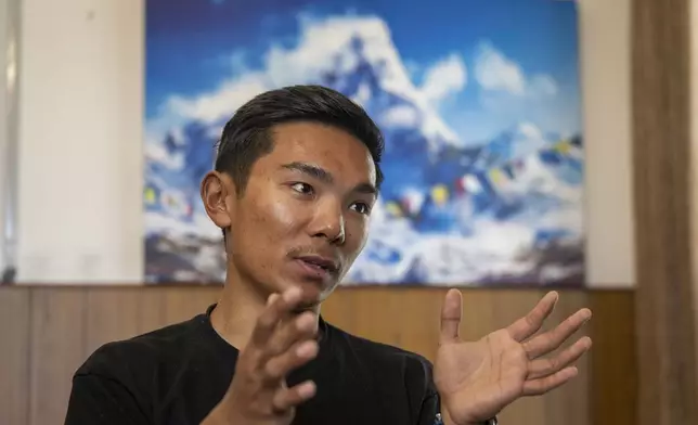 Nima Rinji Sherpa, the youngest person ever to summit the world’s 14 highest peaks speaks during an interview with the Associated Press, in Kathmandu, Nepal, Friday, Oct. 25, 2024. (AP Photo/Niranjan Shrestha)