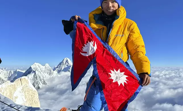 Nima Rinji Sherpa poses for a photograph on top of G2 mountain in Pakistan, July 19, 2023. (14Peakexpedition Via AP)