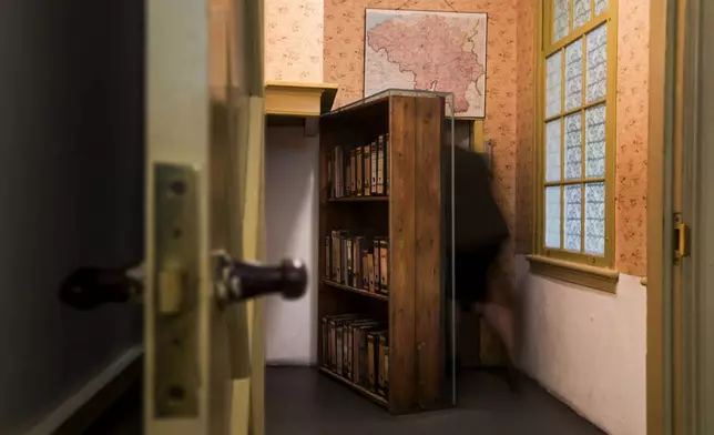 FILE - A woman enters the secret annex at the renovated Anne Frank House Museum in Amsterdam, Netherlands, Wednesday, Nov. 21, 2018. (AP Photo/Peter Dejong, File)