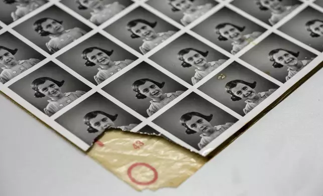 A sheet of pictures of Anne Frank is displayed in Amsterdam, Netherlands, Friday, Oct. 4, 2024, ahead of an exhibit in New York. (AP Photo/Peter Dejong)