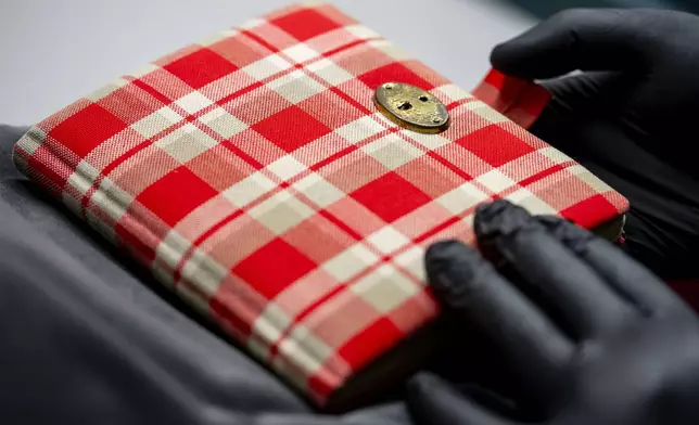 Anne Frank's diary, a red checkered notebook, the cornerstone of the Amsterdam museum's collection, is displayed in Amsterdam, Netherlands, Friday, Oct. 4, 2024. (AP Photo/Peter Dejong)