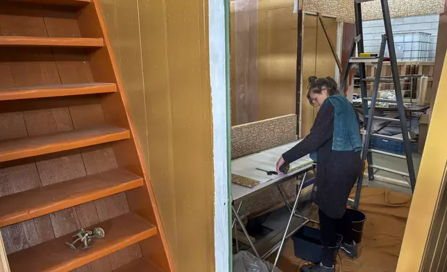 Wallpaper is being prepared for an exact replica of the secret annex which will travel to New York for an exhibit, in the village of Erp, southern Netherlands, Thursday, Oct. 10, 2024. (AP Photo/Aleksandar Furtula)