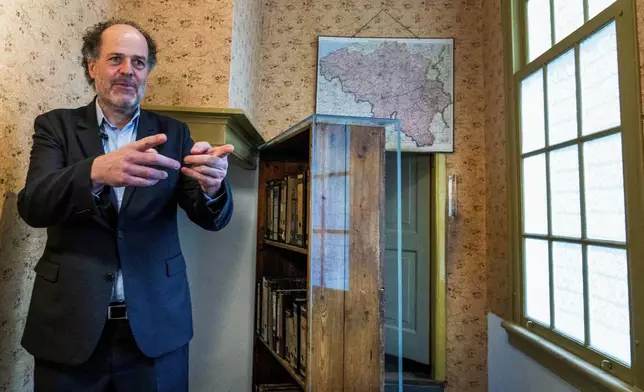 FILE - Ronald Leopold, executive director of the Anne Frank House, gestures as he talks next to the passage to the secret annex during an interview in Amsterdam, Netherlands, Monday, Jan. 17, 2022. (AP Photo/Peter Dejong, File)