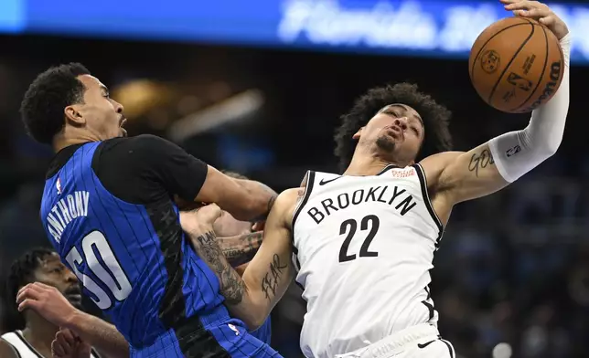 Orlando Magic guard Cole Anthony (50) is fouled by Brooklyn Nets forward Jalen Wilson (22) after going up to shoot during the second half of an NBA basketball game, Friday, Oct. 25, 2024, in Orlando, Fla. (AP Photo/Phelan M. Ebenhack)