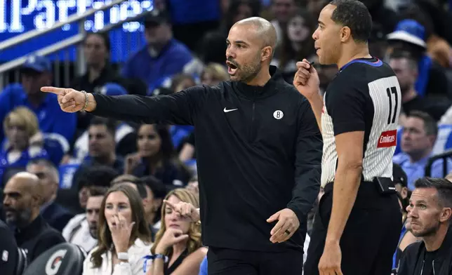 Brooklyn Nets head coach Jordi Fernandez argues a call with official Jonathan Sterling (17) during the first half of an NBA basketball game against the Orlando Magic, Friday, Oct. 25, 2024, in Orlando, Fla. (AP Photo/Phelan M. Ebenhack)