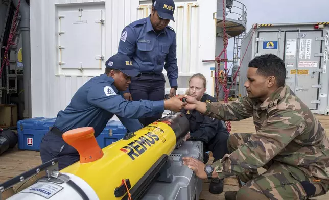 In this undated photo provided by New Zealand's Defence Public Affairs, hydrographers onboard HMNZS Manawanui prep REMUS ready for surveying in Tonga during Op Calypso. (Petty Officer Chris Weissenborn/Defence Public Affairs via AP)