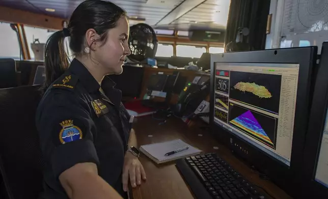 In this undated photo provided by New Zealand's Defence Public Affairs, a hydrographer surveys uncharted positions during the transit to Vanuatu on Op Calypso onboard HMNZS Manawanui. (Petty Officer Chris Weissenborn/Defence Public Affairs via AP)