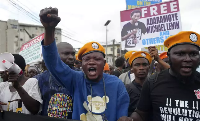 People protest against economic hardship on the occasion of Nigeria's 64th independence anniversary, in Lagos Nigeria, Tuesday, Oct. 1, 2024. (AP Photo/ Sunday Alamba)