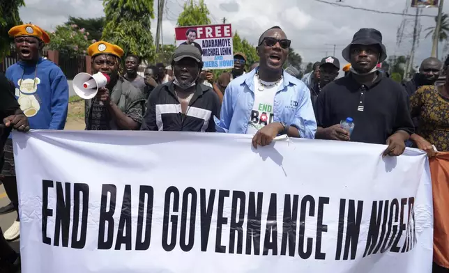 People protest against economic hardship on the occasion of Nigeria's 64th independence anniversary, in Lagos Nigeria, Tuesday, Oct. 1, 2024. (AP Photo/ Sunday Alamba)