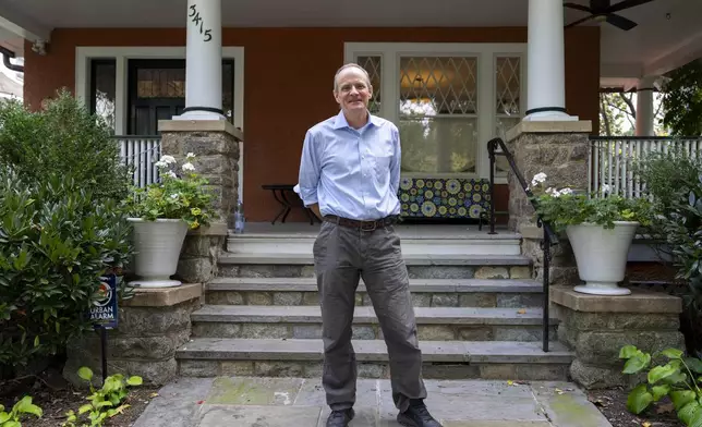 Economist Simon Johnson poses for a photograph after jointly winning the Nobel memorial prize in economics, at his home in Washington, Monday, Oct. 14, 2024. (AP Photo/Ben Curtis)