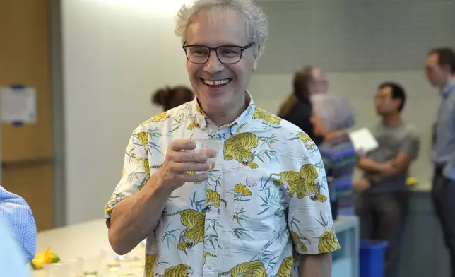 Victor Ambros, 2024 Nobel Prize winner in physiology or medicine, and professor of natural science at the University of Massachusetts Medical School, celebrates with colleagues, at the school, in Worcester, Mass. Monday, Oct. 7, 2024. (AP Photo/Steven Senne)