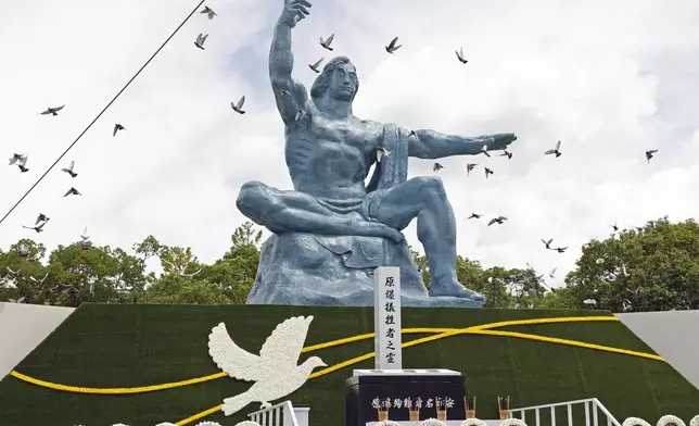 FILE - Doves fly over the Peace Statue during a ceremony to mark the 77th anniversary of the U.S. atomic bombing at the Peace Park in Nagasaki, southern Japan, on Aug. 9, 2022. The Nobel Peace Prize has been awarded to Nihon Hidankyo, a Japanese organization of survivors of the U.S. atomic bombings of Hiroshima and Nagasaki, for its activism against nuclear weapons. (Kyodo News via AP, File)