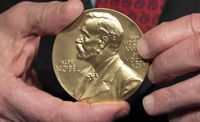 FILE - A close-up view of a Nobel Prize medal at the National Institutes of Health (NIH) in Bethesda, Md., Tuesday, Dec. 8, 2020. (AP Photo/Jacquelyn Martin, File)