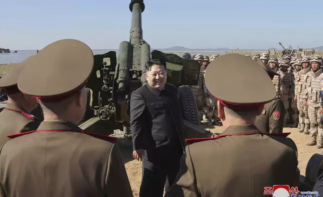 In this undated photo provided on Saturday, Oct. 6, 2024 by the North Korean government, North Korean leader Kim Jong Un, center, visits to watch an artillery exercise at an undisclosed place in North Korea. Independent journalists were not given access to cover the event depicted in this image distributed by the North Korean government. The content of this image is as provided and cannot be independently verified. Korean language watermark on image as provided by source reads: "KCNA" which is the abbreviation for Korean Central News Agency. (Korean Central News Agency/Korea News Service via AP)