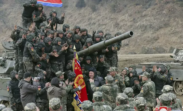 FILE - In this photo provided by the North Korean government, North Korean leader Kim Jong Un, center, meets soldiers who took part in a training in North Korea, on March 13, 2024. Independent journalists were not given access to cover the event depicted in this image distributed by the North Korean government. The content of this image is as provided and cannot be independently verified. Korean language watermark on image as provided by source reads: "KCNA" which is the abbreviation for Korean Central News Agency. (Korean Central News Agency/Korea News Service via AP, File)