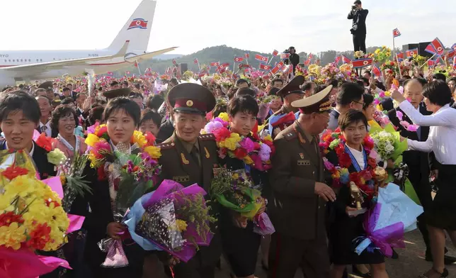 North Korea women's football team members are welcomed on their arrival at the airport in Pyongyang, following their victory at the FIFA U-20 Women's World Cup in Colombia, Saturday, Sept. 28, 2024. (AP Photo/Cha Song Ho)