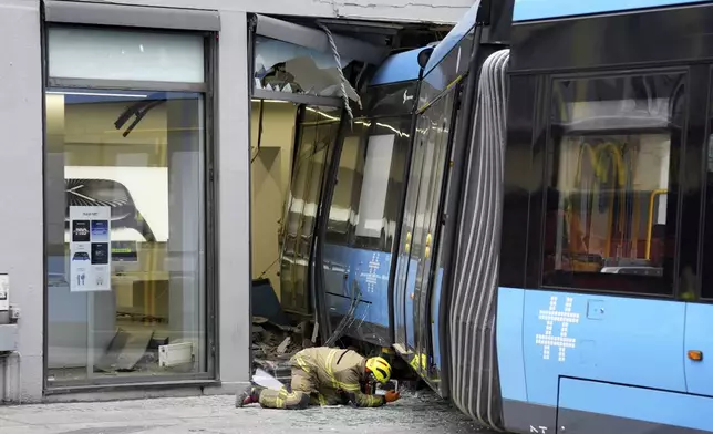 A derailed tram that crashed into a building in downtown Oslo, Norway, Tuesday Oct. 29, 2024. (Terje Pedersen/NTB Scanpix via AP)