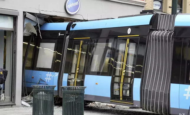 A derailed tram that crashed into a building in downtown Oslo, Norway, Tuesday Oct. 29, 2024. (Terje Pedersen/NTB Scanpix via AP)