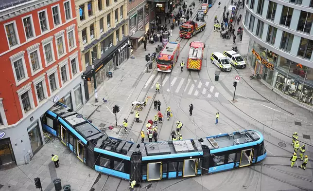 Emergency workers at the scene of a derailed tram that crashed into a building in downtown Oslo, Norway, Tuesday Oct. 29, 2024. (Terje Pedersen/NTB Scanpix via AP)