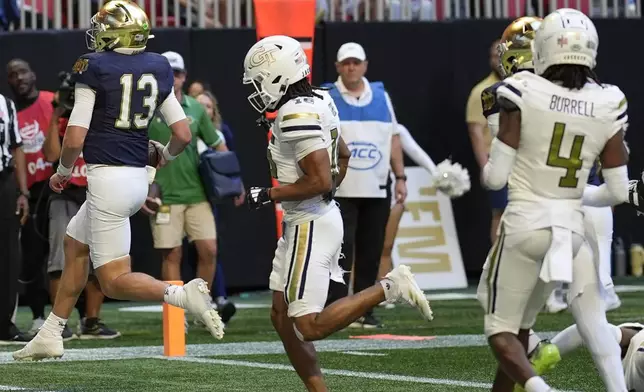 Notre Dame quarterback Riley Leonard (13) runs into the end zone for a touchdown against Georgia Tech during the first half of an NCAA college football game, Saturday, Oct. 19, 2024, in Atlanta. (AP Photo/Mike Stewart)