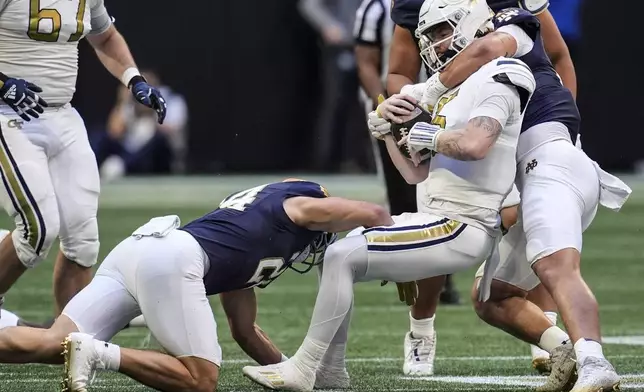 Georgia Tech quarterback Zach Pyron (5) is hit by against Notre Dames during the first half of an NCAA college football game, Saturday, Oct. 19, 2024, in Atlanta. (AP Photo/Mike Stewart)