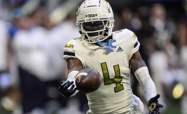 Georgia Tech defensive back Warren Burrell (4) intercepts the ball off Notre Dame quarterback Riley Leonard during the first half of an NCAA college football game, Saturday, Oct. 19, 2024, in Atlanta. (AP Photo/Mike Stewart)