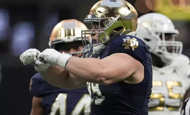 Notre Dame defensive lineman Rylie Mills (99) celebrates a sack of Georgia Tech quarterback Zach Pyron during the second half of an NCAA college football game, Saturday, Oct. 19, 2024, in Atlanta. (AP Photo/Mike Stewart)