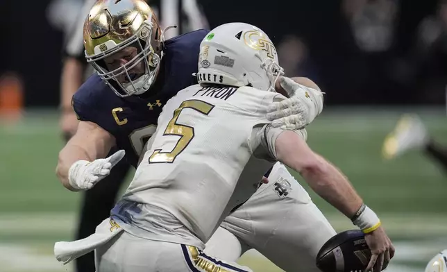 Notre Dame defensive lineman Rylie Mills (99) hits Georgia Tech quarterback Zach Pyron (5) during the second half of an NCAA college football game, Saturday, Oct. 19, 2024, in Atlanta. (AP Photo/Mike Stewart)