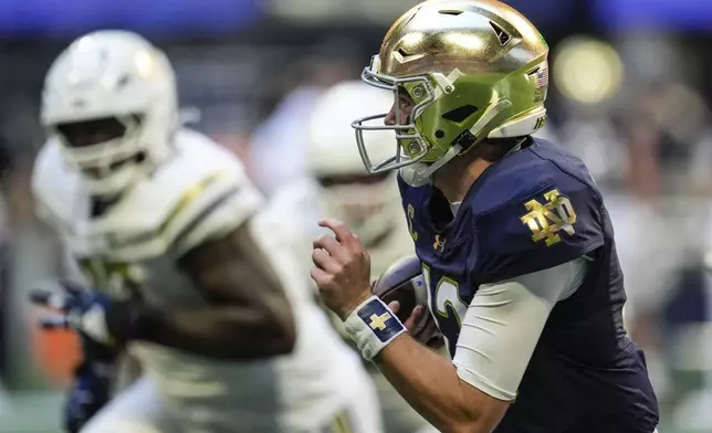 Notre Dame quarterback Riley Leonard (13) runs out of the pocket against Georgia Tech during the first half of an NCAA college football game, Saturday, Oct. 19, 2024, in Atlanta. (AP Photo/Mike Stewart)