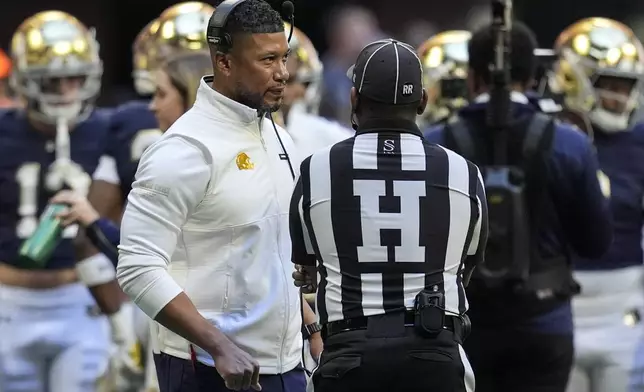 Georgia Tech head coach Brent Key speaks with an official during the first half of an NCAA college football game against Notre Dame, Saturday, Oct. 19, 2024, in Atlanta. (AP Photo/Mike Stewart)