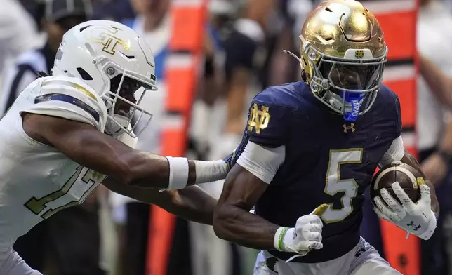 Notre Dame wide receiver Beaux Collins (5) runs against Georgia Tech linebacker Jackson Hamilton (17) during the first half of an NCAA college football game, Saturday, Oct. 19, 2024, in Atlanta. (AP Photo/Mike Stewart)