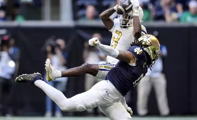 Georgia Tech wide receiver Malik Rutherford (8) makes the catch against Notre Dame safety Xavier Watts (0) during the first half of an NCAA college football game, Saturday, Oct. 19, 2024, in Atlanta. (AP Photo/Mike Stewart)