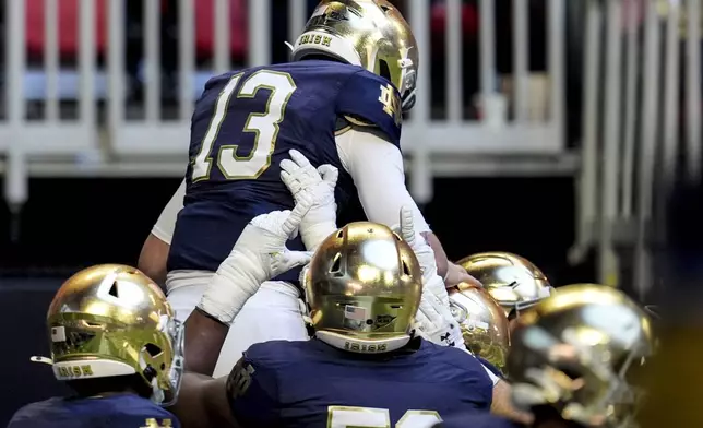 Notre Dame quarterback Riley Leonard (13) celebrates his touchdown against Georgia Tech during the first half of an NCAA college football game, Saturday, Oct. 19, 2024, in Atlanta. (AP Photo/Mike Stewart)