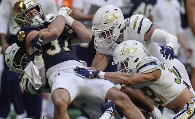 Notre Dame cornerback Max Hurleman (37) is hit by against Georgia Tech on a punt return during the first half of an NCAA college football game, Saturday, Oct. 19, 2024, in Atlanta. (AP Photo/Mike Stewart)