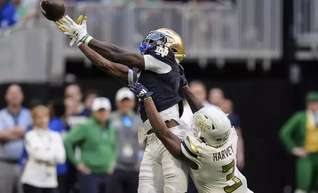 Notre Dame wide receiver Beaux Collins (5) misses the catch against Georgia Tech defensive back Ahmari Harvey (3) during the second half of an NCAA college football game, Saturday, Oct. 19, 2024, in Atlanta. (AP Photo/Mike Stewart)