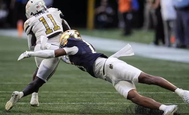 Georgia Tech running back Jamal Haynes (11) runs against Notre Dame cornerback Leonard Moore (15) during the first half of an NCAA college football game, Saturday, Oct. 19, 2024, in Atlanta. (AP Photo/Mike Stewart)