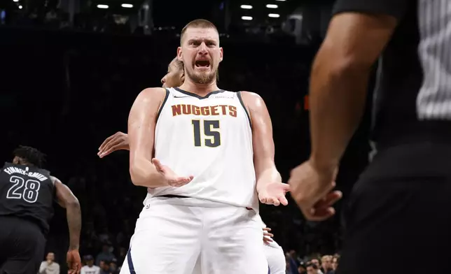 Denver Nuggets' Nikola Jokic (15), of Serbia, reacts to a call during the third quarter of an NBA basketball game against the Brooklyn Nets, Tuesday, Oct. 29, 2024, in New York. (AP Photo/Jason DeCrow)