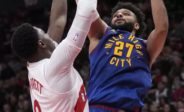 Denver Nuggets guard Jamal Murray (27) shoots past Toronto Raptors guard RJ Barrett (9) during second-half NBA basketball game action in Toronto, Monday, Oct. 28, 2024. (Nathan Denette/The Canadian Press via AP)